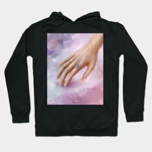 Female Hand With Purple Rings Touching a Soft Purple Fabric Hoodie